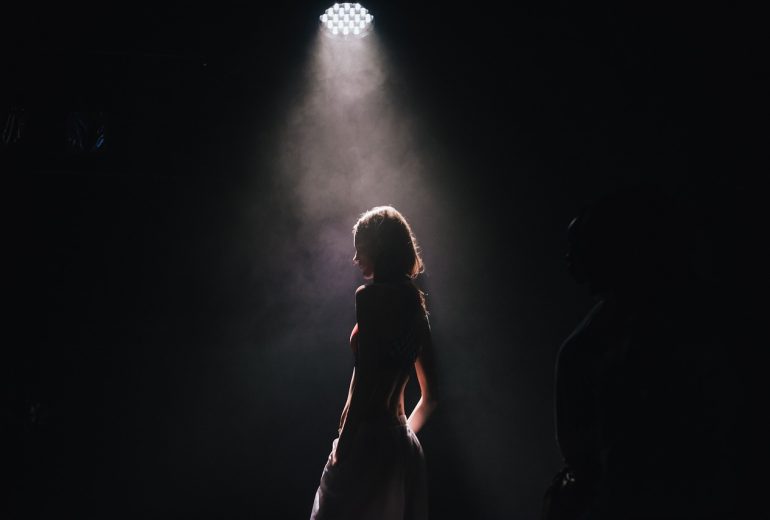 spotlight on girl in sillouette