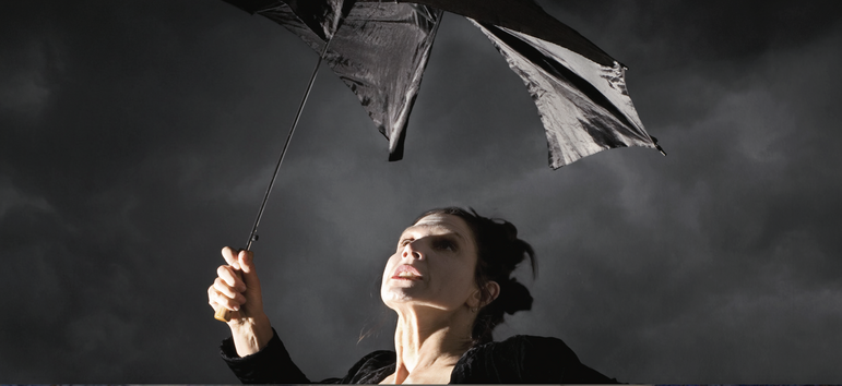 woman with broken umbrella in a storm